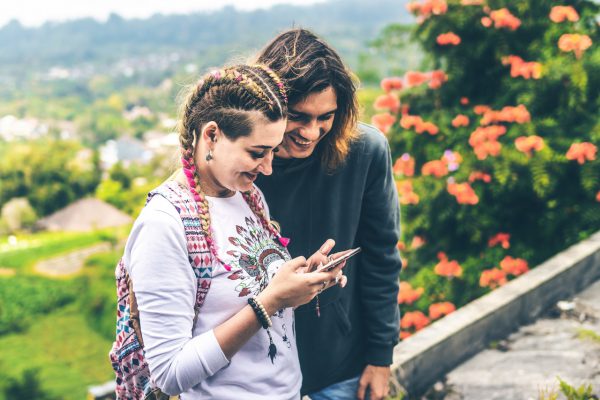 photo-of-man-and-woman-smiling-looking-at-mobile-phone-2613331
