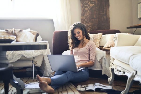 woman-smiling-while-using-laptop-3769717